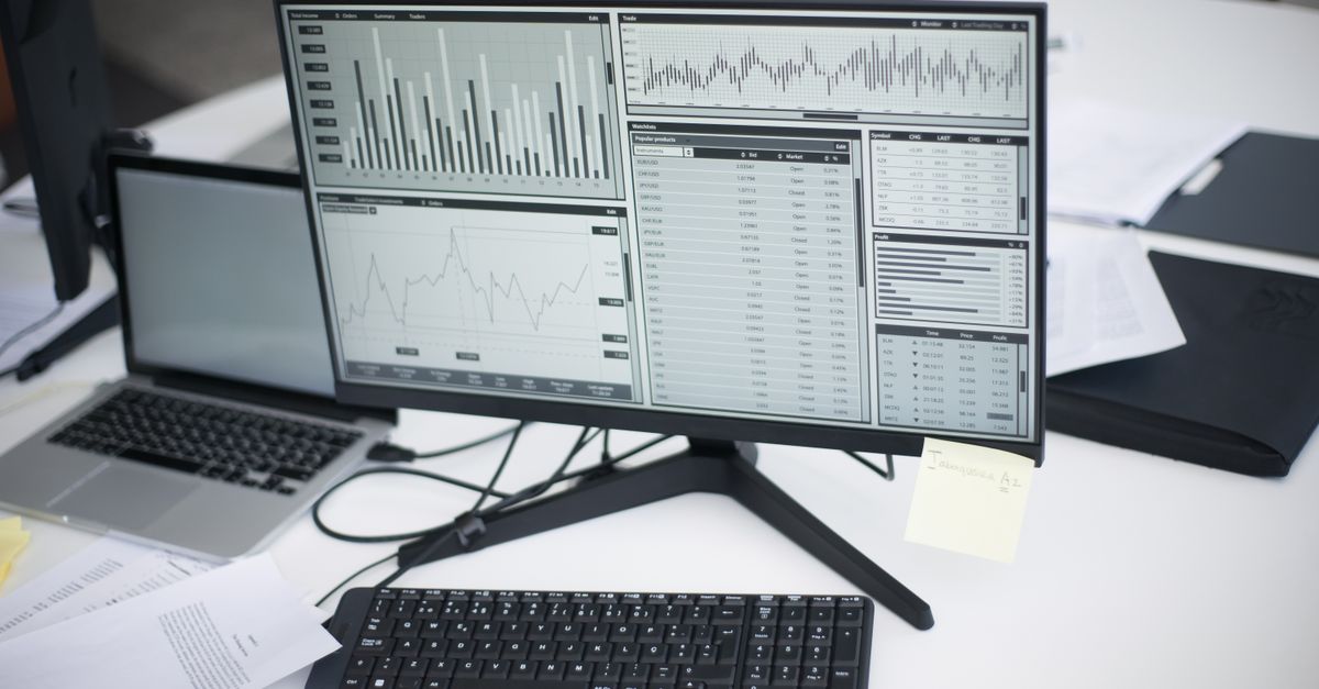 A laptop showing business charts on a desk