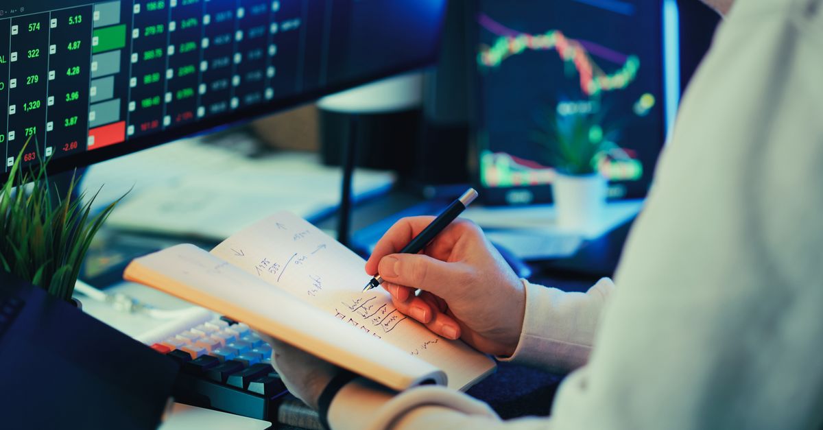 A finance professional reviewing financial dashboards on screen