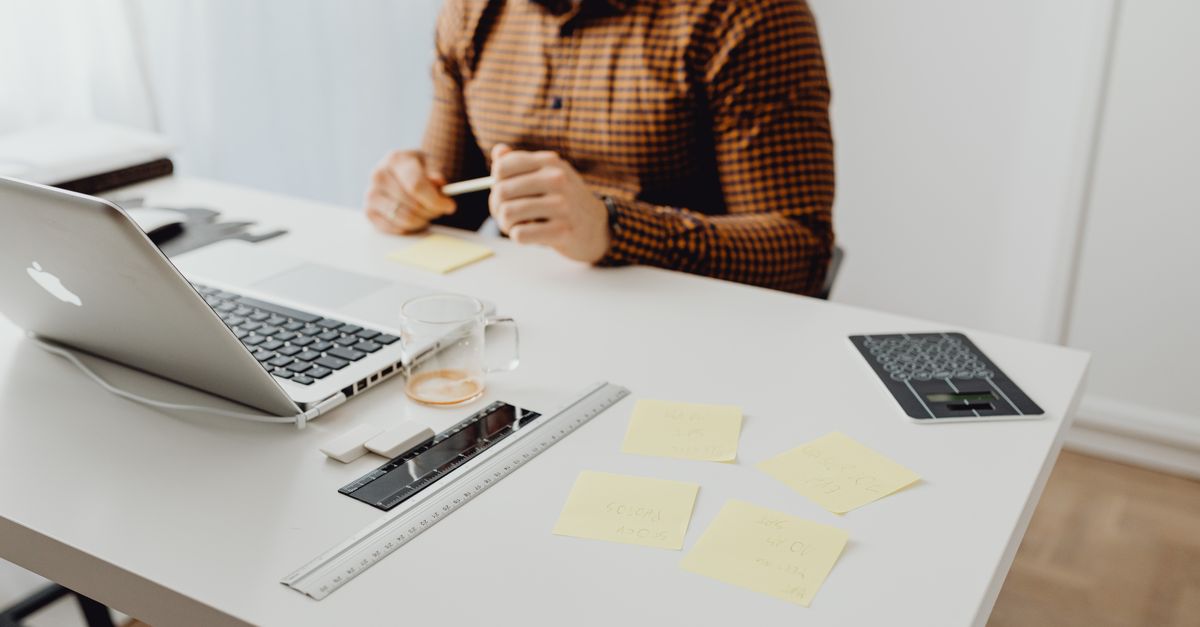 A business owner reviewing several companies’ finances at one desk